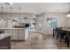 The dining area has wood tile floors, a black table with chairs, and modern light fixtures at 1319 N Chatsworth St, Mesa, AZ 85207