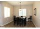 Dining room featuring a dark wood table and chairs with a modern chandelier at 1319 N Chatsworth St, Mesa, AZ 85207