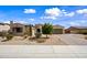 Inviting single-story home with desert landscaping, brick driveway, and charming architectural details at 1319 N Chatsworth St, Mesa, AZ 85207