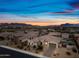 Stunning desert home with beautiful landscaping and a tile roof set against a vibrant sunset sky at 1319 N Chatsworth St, Mesa, AZ 85207