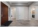 Inviting foyer featuring a rich wood door, neutral walls, and wood-look tile flooring at 1319 N Chatsworth St, Mesa, AZ 85207