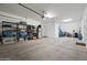 Spacious garage with a concrete floor, ample shelving, storage, and room for parking and hobbies at 1319 N Chatsworth St, Mesa, AZ 85207
