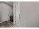Hallway with wood floor, white doors, and a dark wood cabinet with decorative sign that says, 