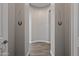 Neutral hallway with tile flooring and horseshoe art at 1319 N Chatsworth St, Mesa, AZ 85207