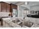 Close-up of a kitchen island with double sinks, granite countertops, and stainless steel appliances at 1319 N Chatsworth St, Mesa, AZ 85207