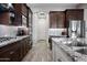 Well-equipped kitchen with stainless steel appliances, tile backsplash, and ample counter space at 1319 N Chatsworth St, Mesa, AZ 85207