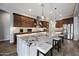 Spacious kitchen with a large island, granite countertops, stainless steel appliances, and pendant lighting at 1319 N Chatsworth St, Mesa, AZ 85207
