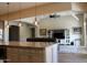 Bright open-concept space adjoining the kitchen with living area with fan and media center at 1319 N Chatsworth St, Mesa, AZ 85207