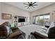 Living room boasts a gray rug, leather couches, large sliding glass doors and ceiling fan at 1319 N Chatsworth St, Mesa, AZ 85207