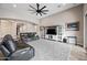 A living room featuring a gray rug, leather couches, and a ceiling fan at 1319 N Chatsworth St, Mesa, AZ 85207