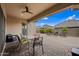 Inviting outdoor patio area with dining table, seating, and a cozy fireplace for relaxation and entertaining at 1319 N Chatsworth St, Mesa, AZ 85207