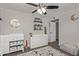 Bright bedroom with a ceiling fan, wood floors, a plush rug, and updated furniture at 1340 N Recker Rd # 118, Mesa, AZ 85205