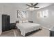 Well-lit bedroom featuring a large window and a large painting above the comfortable-looking bed at 1340 N Recker Rd # 118, Mesa, AZ 85205