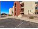 Exterior view of the building showcasing its architecture, landscaping, and parking area at 1340 N Recker Rd # 118, Mesa, AZ 85205