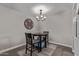 A quaint dining space highlighted by a modern chandelier and a round table with seating for two at 1340 N Recker Rd # 118, Mesa, AZ 85205