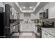 Well-lit kitchen featuring granite countertops, stainless steel appliances, and modern white cabinetry at 1340 N Recker Rd # 118, Mesa, AZ 85205