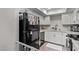 Bright kitchen featuring white cabinets, granite countertops, stainless appliances, and wood-look floors at 1340 N Recker Rd # 118, Mesa, AZ 85205