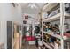 Functional laundry area equipped with a washer, dryer, shelving, and storage solutions at 1340 N Recker Rd # 118, Mesa, AZ 85205