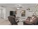 Comfortable living room featuring wood floors, ceiling fan, modern decor, and an abundance of natural light at 1340 N Recker Rd # 118, Mesa, AZ 85205