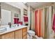 Bathroom features a wood vanity, framed mirror, and shower curtain at 13410 N Cedar Dr, Sun City, AZ 85351