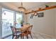 Bright dining area with sliding glass doors, decorative shelving, and inviting natural light at 13410 N Cedar Dr, Sun City, AZ 85351