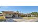 Charming single-story home featuring a covered carport, well-manicured lawn, and traditional design elements at 13410 N Cedar Dr, Sun City, AZ 85351