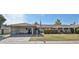 Charming single-story home featuring a covered carport, well-manicured lawn, and traditional design elements at 13410 N Cedar Dr, Sun City, AZ 85351