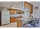 Inviting kitchen with breakfast bar seating, wooden cabinets, granite countertops, and modern appliances at 13410 N Cedar Dr, Sun City, AZ 85351