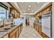 Functional kitchen with wood cabinetry, neutral countertops, and updated appliances at 13410 N Cedar Dr, Sun City, AZ 85351