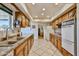 Spacious kitchen with ample cabinet space, granite countertops, and tile flooring for practical cooking at 13410 N Cedar Dr, Sun City, AZ 85351