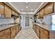 Functional kitchen layout with modern appliances, granite countertops, and tile flooring for easy maintenance at 13410 N Cedar Dr, Sun City, AZ 85351