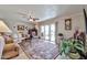 Bright living room with sliding glass doors leading to a backyard, a ceiling fan, and comfortable furnishings at 13410 N Cedar Dr, Sun City, AZ 85351