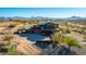 Exterior aerial of a home with a putting green, unique roof design, and outdoor patio with a pool at 14426 N Vista Del Oro --, Scottsdale, AZ 85264