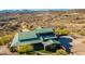 Aerial view of the property displaying green roof, patio, putting green, and circular driveway in desert landscape at 14426 N Vista Del Oro --, Scottsdale, AZ 85264