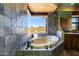 Soaking tub with bronze fixtures next to a window looking out to a desert landscape at 14426 N Vista Del Oro --, Scottsdale, AZ 85264
