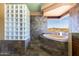 Bathroom with a glass block shower and a soaking tub next to a window looking out to a scenic view at 14426 N Vista Del Oro --, Scottsdale, AZ 85264