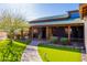 Home exterior with manicured lawn, desert landscaping, covered porch, and decorative exterior lighting at 14426 N Vista Del Oro --, Scottsdale, AZ 85264