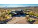An exterior elevation shot of the house with a circular driveway, putting green and beautiful desert landscape at 14426 N Vista Del Oro --, Scottsdale, AZ 85264