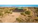 Desert home with green metal roof, a deck and patio, a fire pit, and mature desert landscaping at 14426 N Vista Del Oro --, Scottsdale, AZ 85264