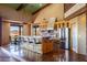 Large kitchen with granite counters, stainless steel appliances, brick accents, and an adjacent dining area at 14426 N Vista Del Oro --, Scottsdale, AZ 85264