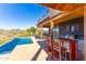 Poolside outdoor kitchen and bar area featuring a grill and counter seating overlooking desert views at 14426 N Vista Del Oro --, Fort McDowell, AZ 85264