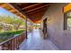 Long covered porch with wood ceiling and tile flooring overlooking the landscaped lawn and desert hillside at 14426 N Vista Del Oro --, Scottsdale, AZ 85264