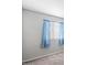 Bedroom with a window, light blue curtains, white trim, and neutral flooring at 15002 W Heritage Oak Way, Surprise, AZ 85374