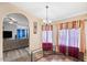 Bright dining area with stylish chandelier and views into the living room at 15002 W Heritage Oak Way, Surprise, AZ 85374