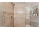 Tiled shower with glass partition, decorative horizontal accent and built-in shelf with toiletries at 15095 N Thompson Peak Pkwy # 1053, Scottsdale, AZ 85260