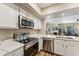 Well-equipped kitchen with stainless steel appliances, white cabinets, and ample counter space, ideal for cooking at 15095 N Thompson Peak Pkwy # 1053, Scottsdale, AZ 85260
