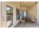 Outdoor patio with a small table, chairs, and view through sliding glass doors at 15095 N Thompson Peak Pkwy # 1053, Scottsdale, AZ 85260