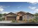 Charming single-story home with a two-car garage, tile roof, and desert landscaping at 17157 W Oberlin Way, Surprise, AZ 85387