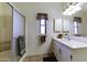 Bright bathroom with a shower, single vanity, and ample cabinet space at 17200 W Bell Rd # 1551, Surprise, AZ 85374