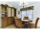 Dining room with a wood table, chairs, and a built-in cabinet at 17200 W Bell Rd # 1551, Surprise, AZ 85374